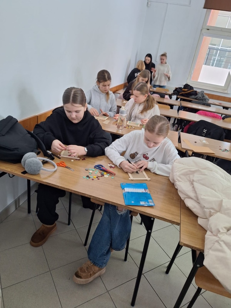 Dzieci na warsztatach przyrodniczych tworzą prace z materiałów naturalnych.