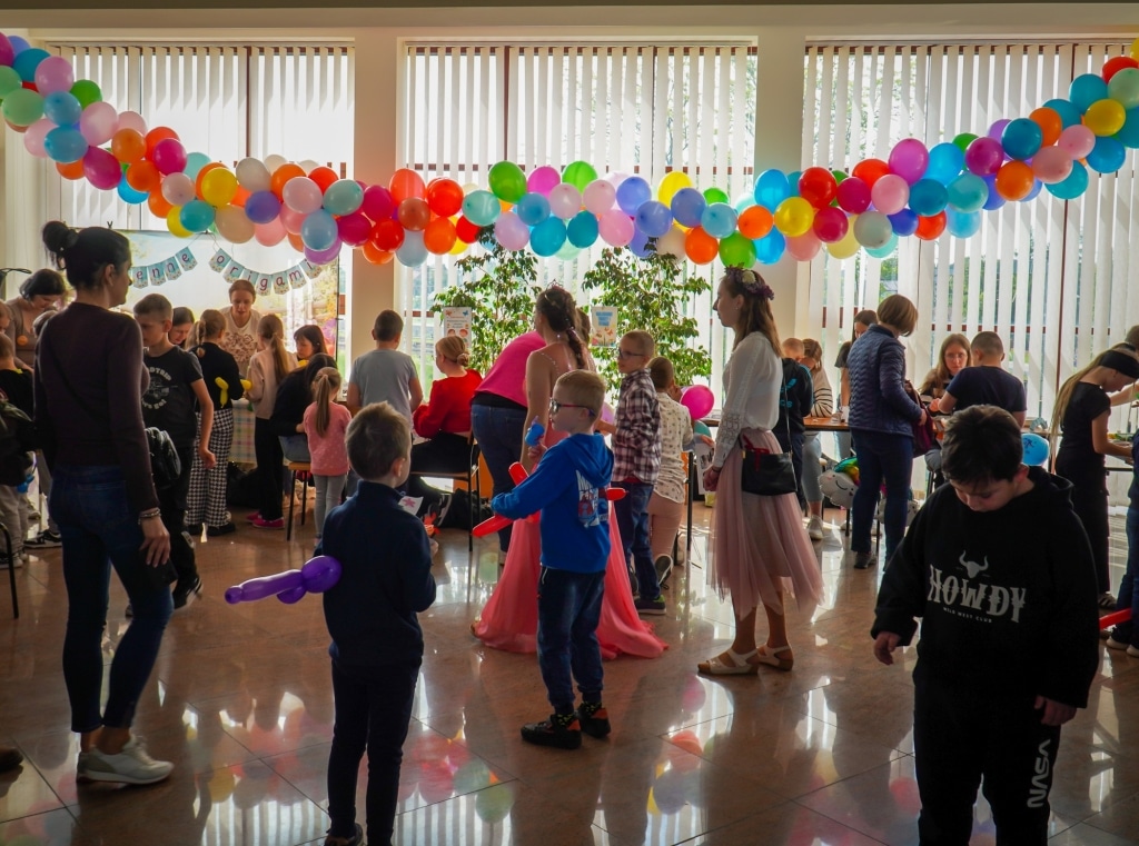 Dzieci i dorośli na Festiwalu Kreatywności w PANS Jarosław wśród balonów.