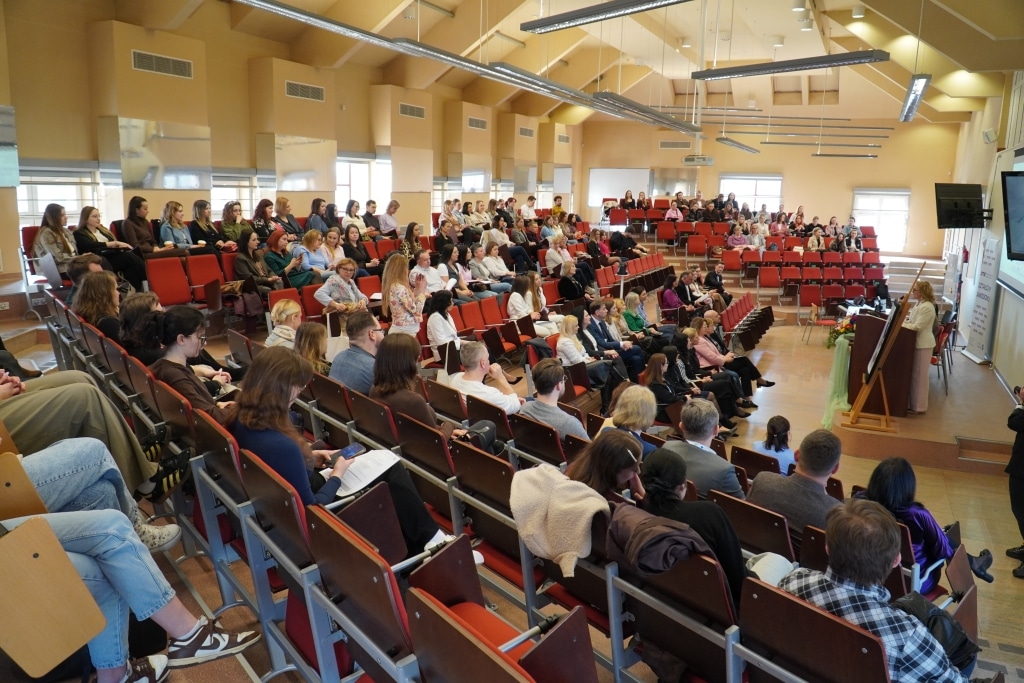 Uczestnicy konferencji naukowej o odporności psychicznej siedzą w sali wykładowej.