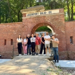 Grupa studentów na wyjeździe studyjnym przed historycznym fortem Lacrfort Salis.