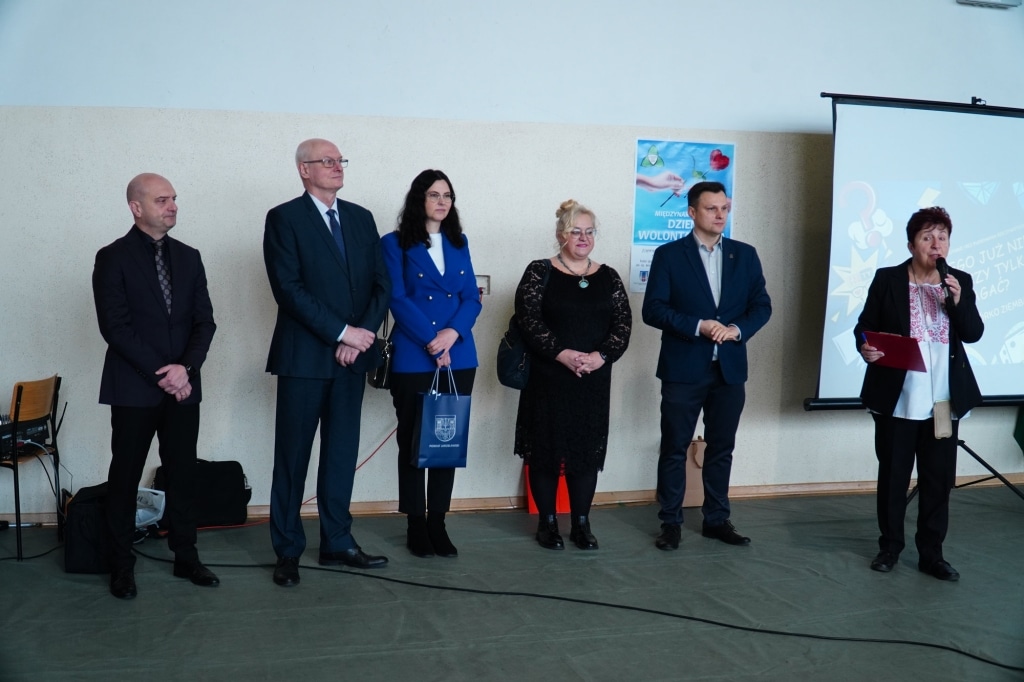 Uczestnicy gali wolontariatu, w tym mówczyni przy mównicy.
