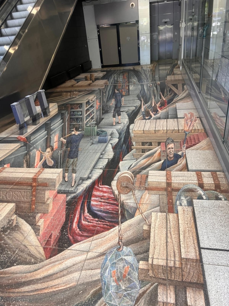 Iluzja 3D na chodniku z motywem warsztatów storytellingu