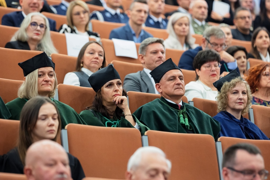Inauguracja 2025/2026: Uczestnicy w togach w auli uniwersyteckiej.