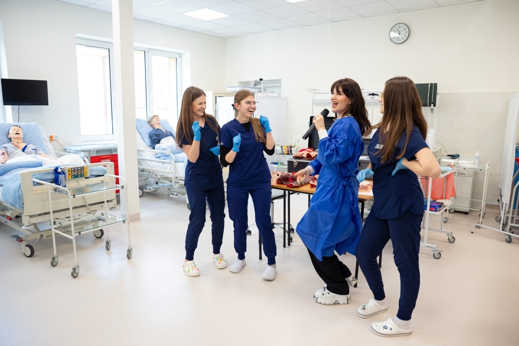 Studenci medycyny na Dniu Otwartym 2025 bawią się w sali symulacyjnej.