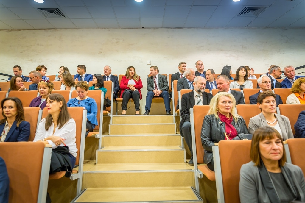 Uczestnicy Inauguracji Roku Akademickiego 2018/2019 siedzą w auli.